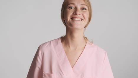 caucasian female doctor happily wearing medical gloves.