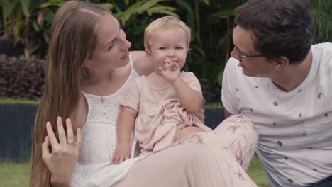 madre y padre besando a un niño pequeño