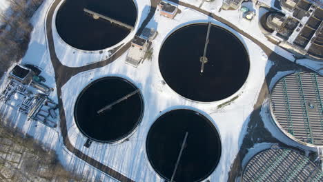 Aerial-tilt-down-of-sewage-water-treatment-plant-basins-in-winter