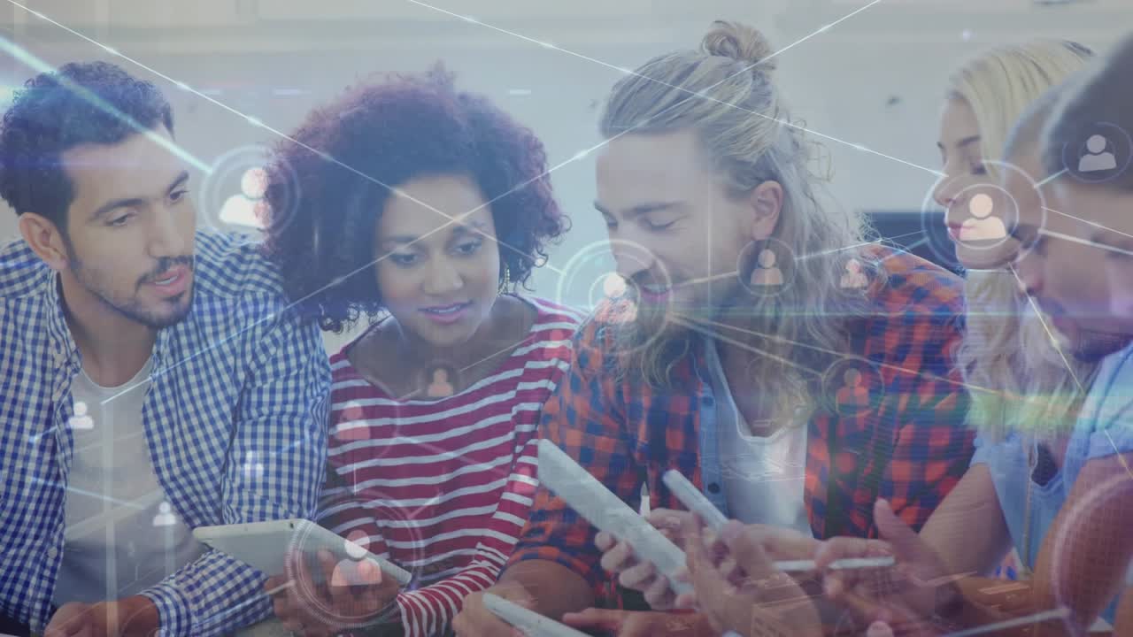 Animation of network of profile icons over team of diverse colleagues discussing together at office