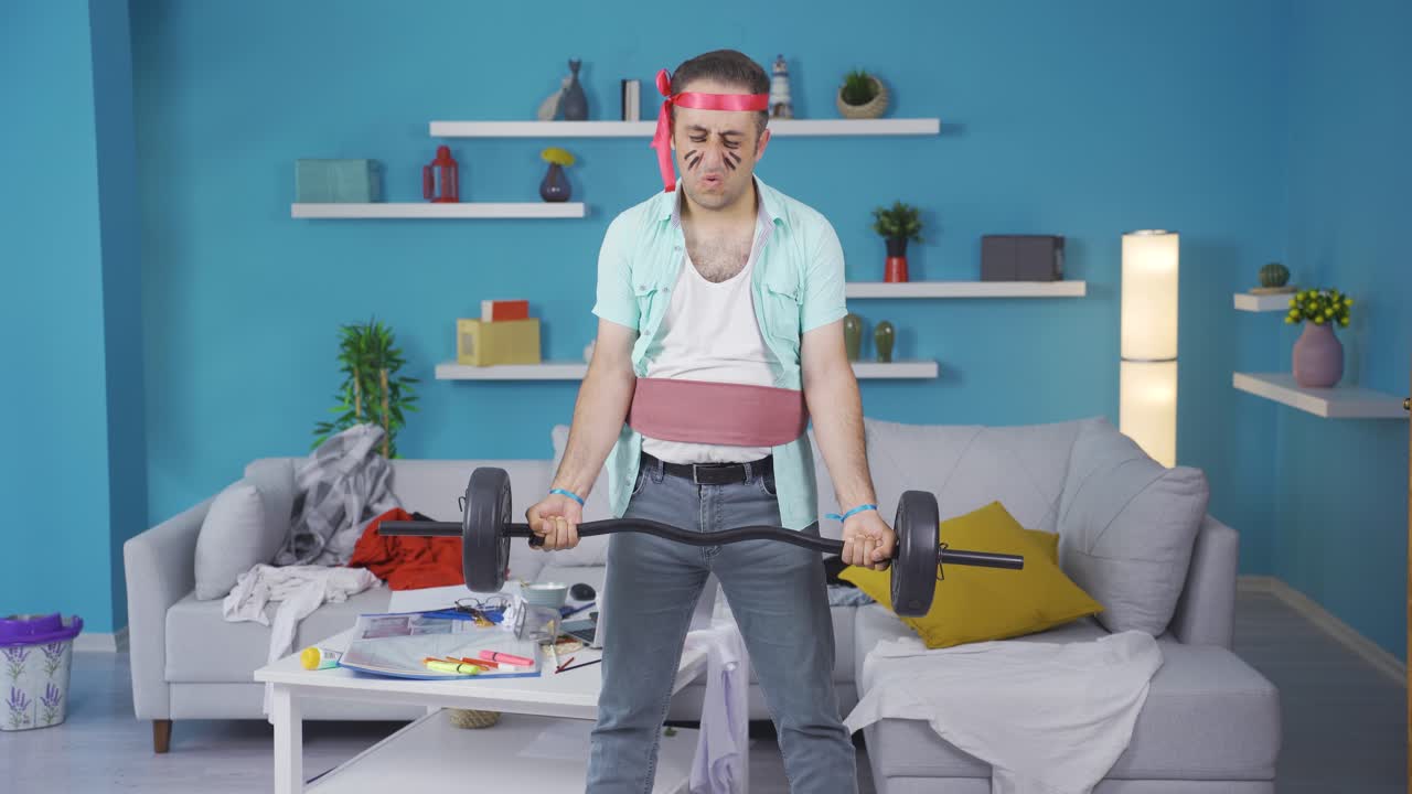 Funny man working muscle can't lift the weight.