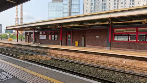 a train approaches and stops at the platform