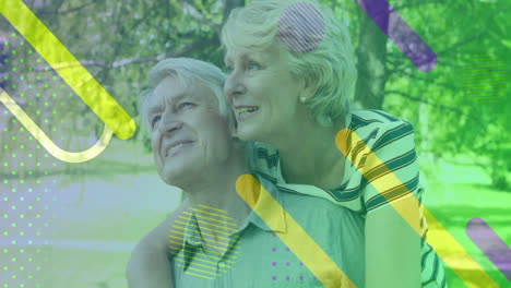 embracing outdoors, elderly couple with colorful abstract animation shapes overlay