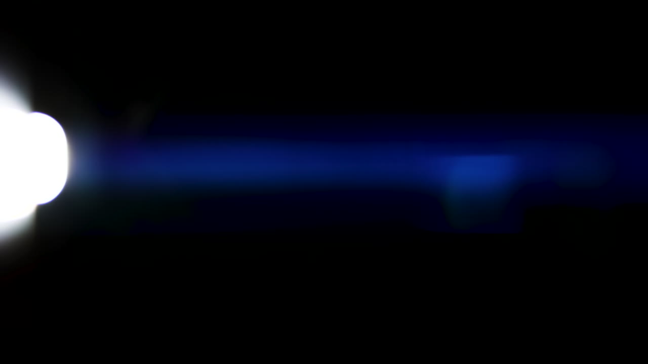 Beautiful, stunning light reflections and anamorphic blue streaks shot on black with high-end cinema anamorphic lens as a background, light leak overlays or transitions for editors