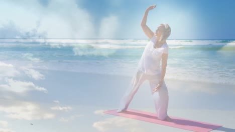 animation of glowing light over senior woman practicing yoga by seaside