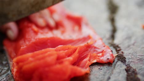 cutting, cleaning, and gutting a wild salmon with a knife