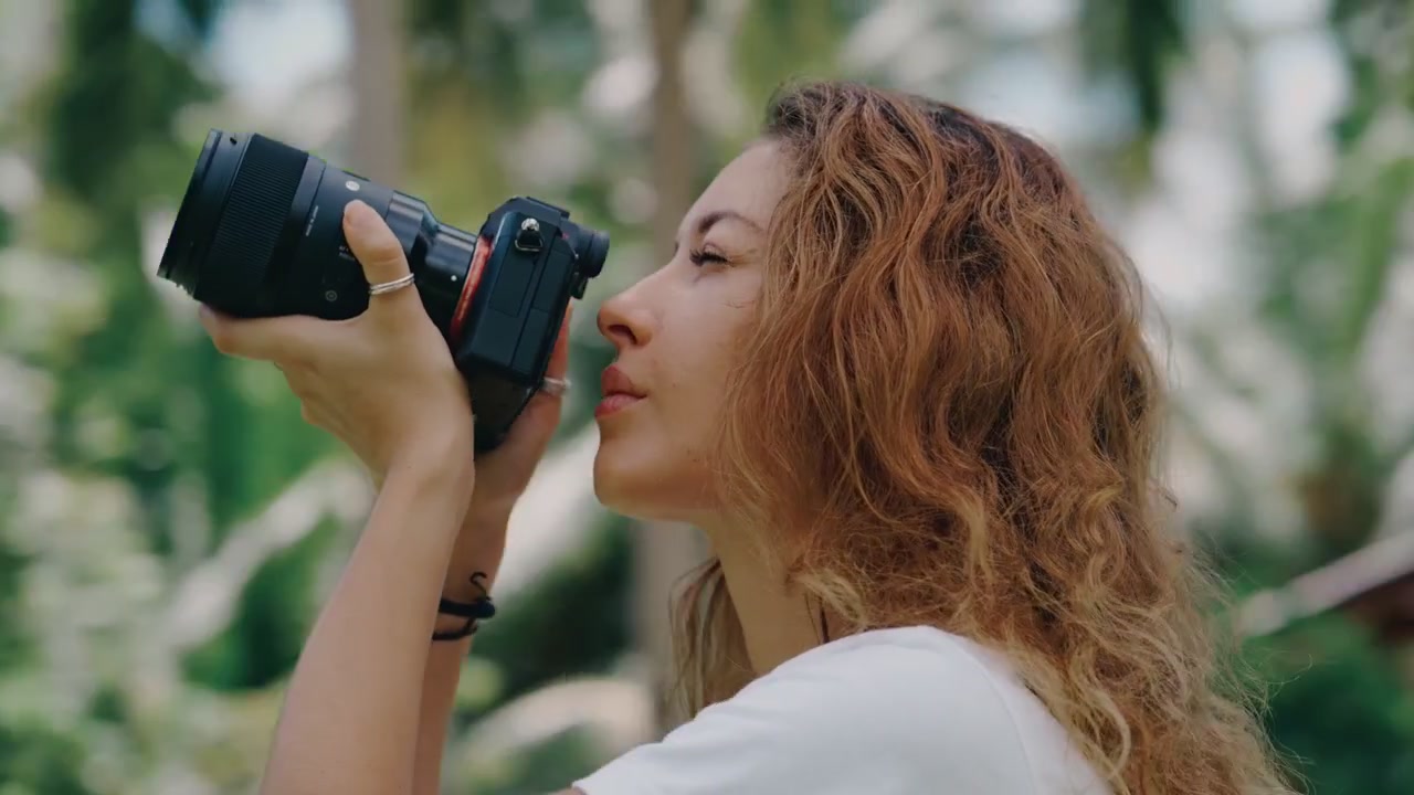 Young Woman Taking Photos with Professional Camera in Tropical Setting