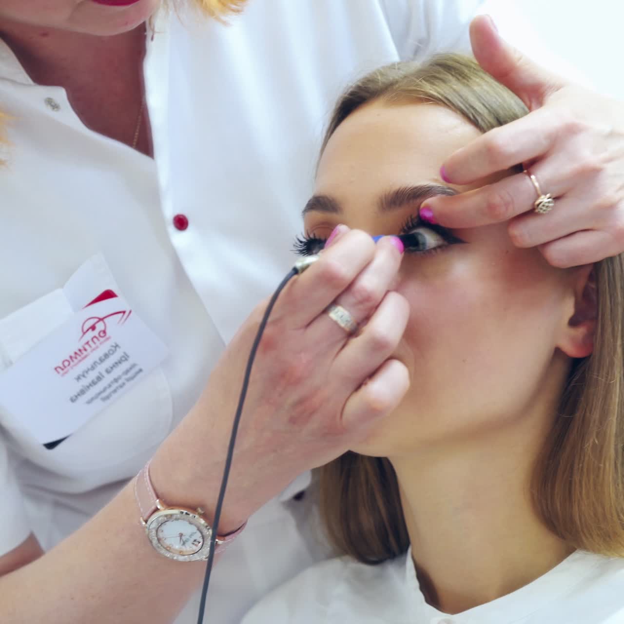 Female ophthalmologist treat patient's eye. Doctor with ophthalmological tool during surgical treatment in clinic.