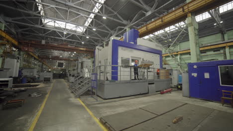 factory worker operating large industrial machine