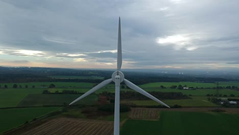 Slow-pull-back-reveal-of-wind-turbine-in-British-countryside