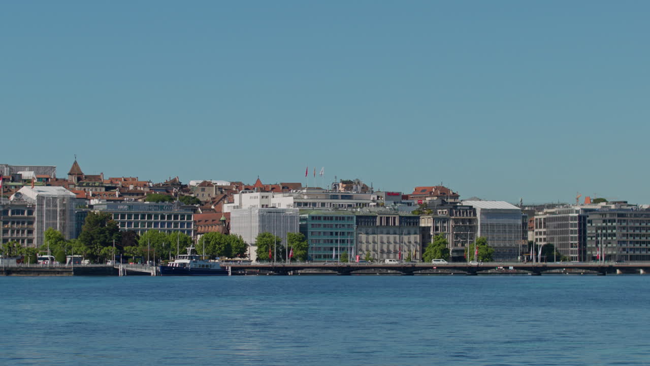 Peaceful morning in Geneva with the iconic Jet d’Eau rising from the lake, calm waters reflecting the clear sky, and the city slowly coming to life in the morning light.