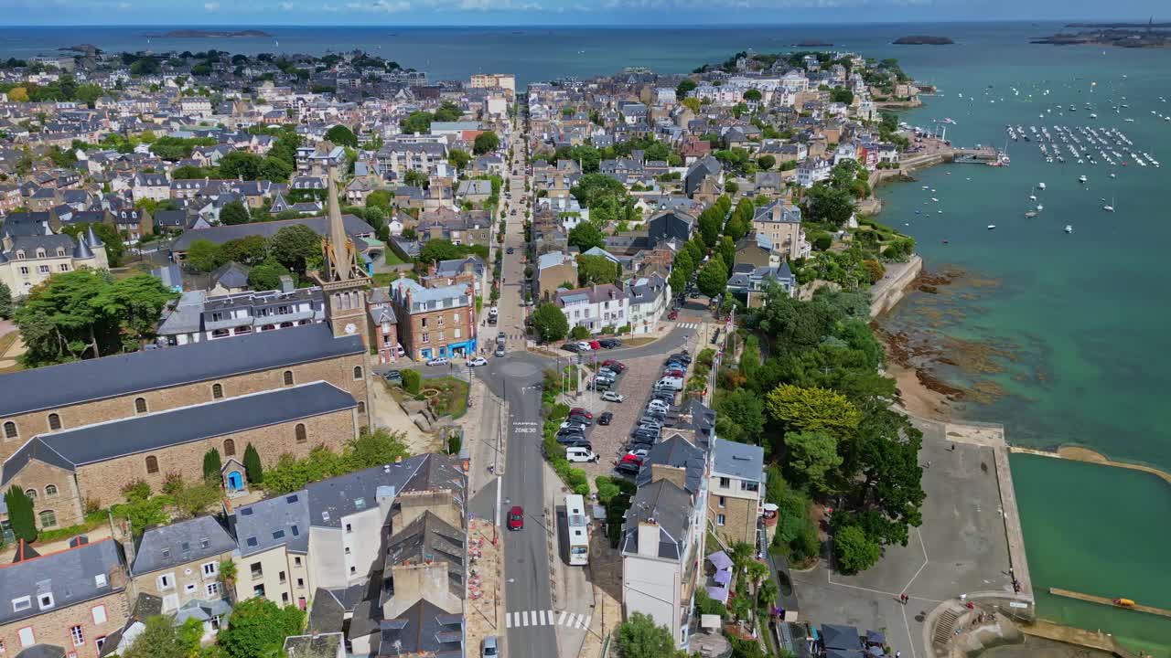 Drone establishing of Eglise Notre Dame d’Emeraude in Dinard with coastal city and trees around