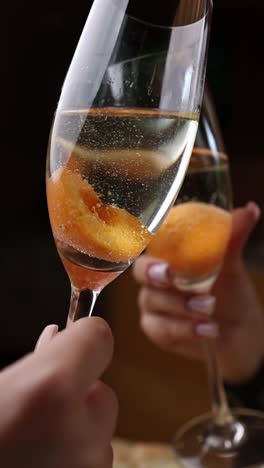 cheers with peach sparkling wine