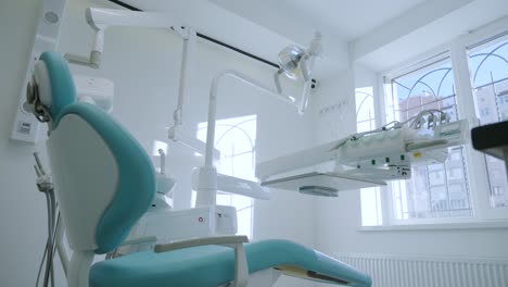 modern dental practice. dental chair and other accessories used by dentists in blue, medic light.