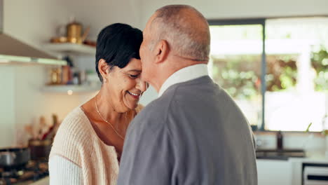 Love,-senior-couple-and-kiss-on-forehead-in-home