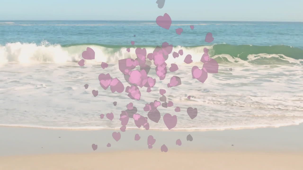 Pink heart animation over ocean waves gently hitting sandy beach