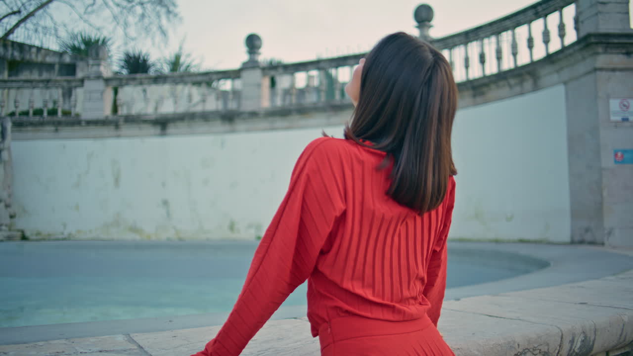 Gorgeous tourist girl looking distance standing alone near fountain city closeup
