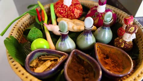 a vibrant display of herbal compress ingredients for a thai massage, showcasing natural elements and traditional techniques in a serene setting