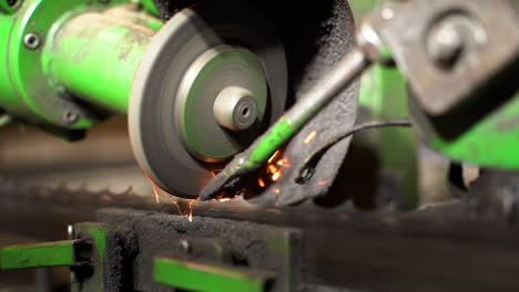 automatic band saw blade sharpening with industrial machinery in closeup