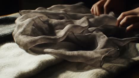 a textured composition featuring various fabrics: cozy knits and delicate drapes in soft natural light
