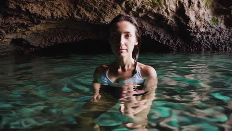 woman swimming in a beautiful natural cave grotto