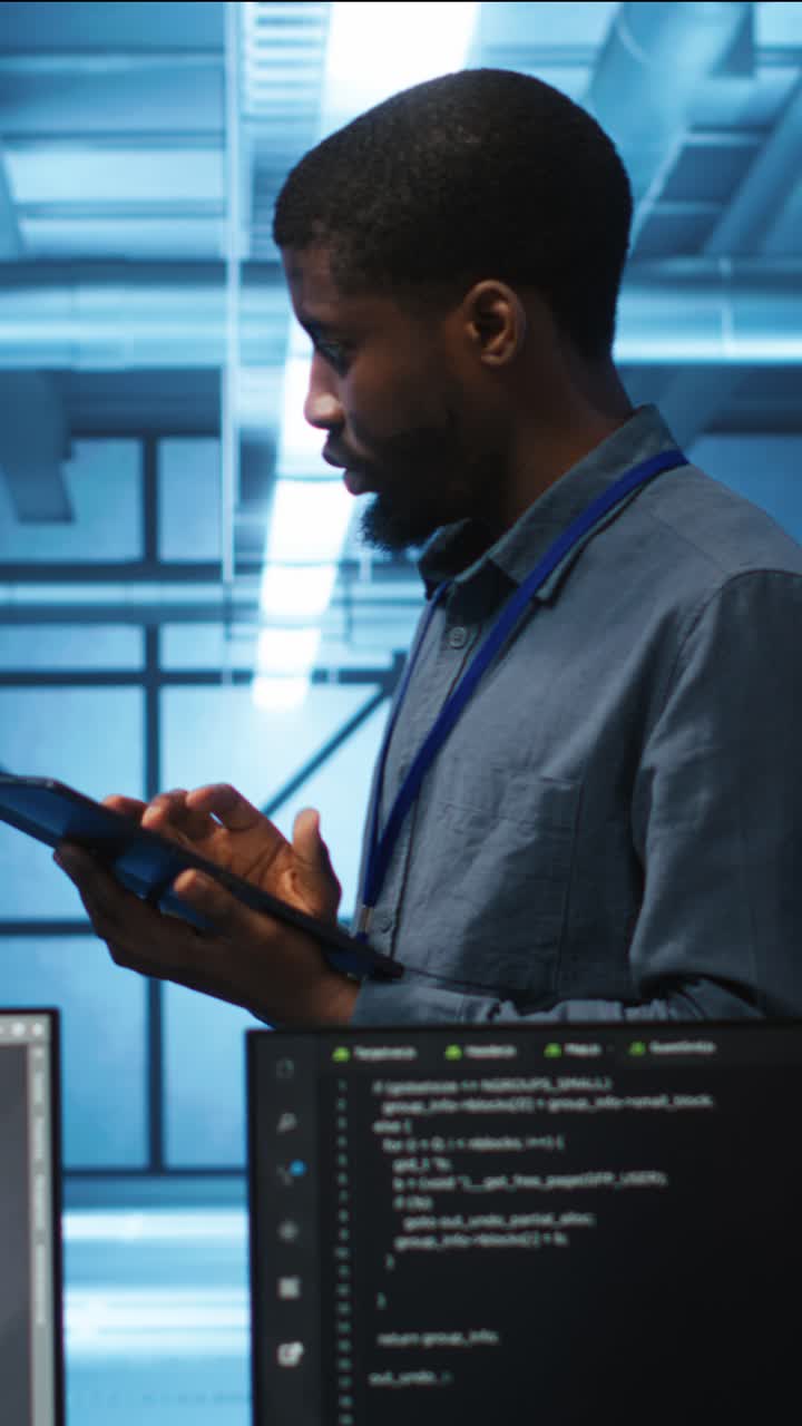 African American Man Working on Tablet in Server Room