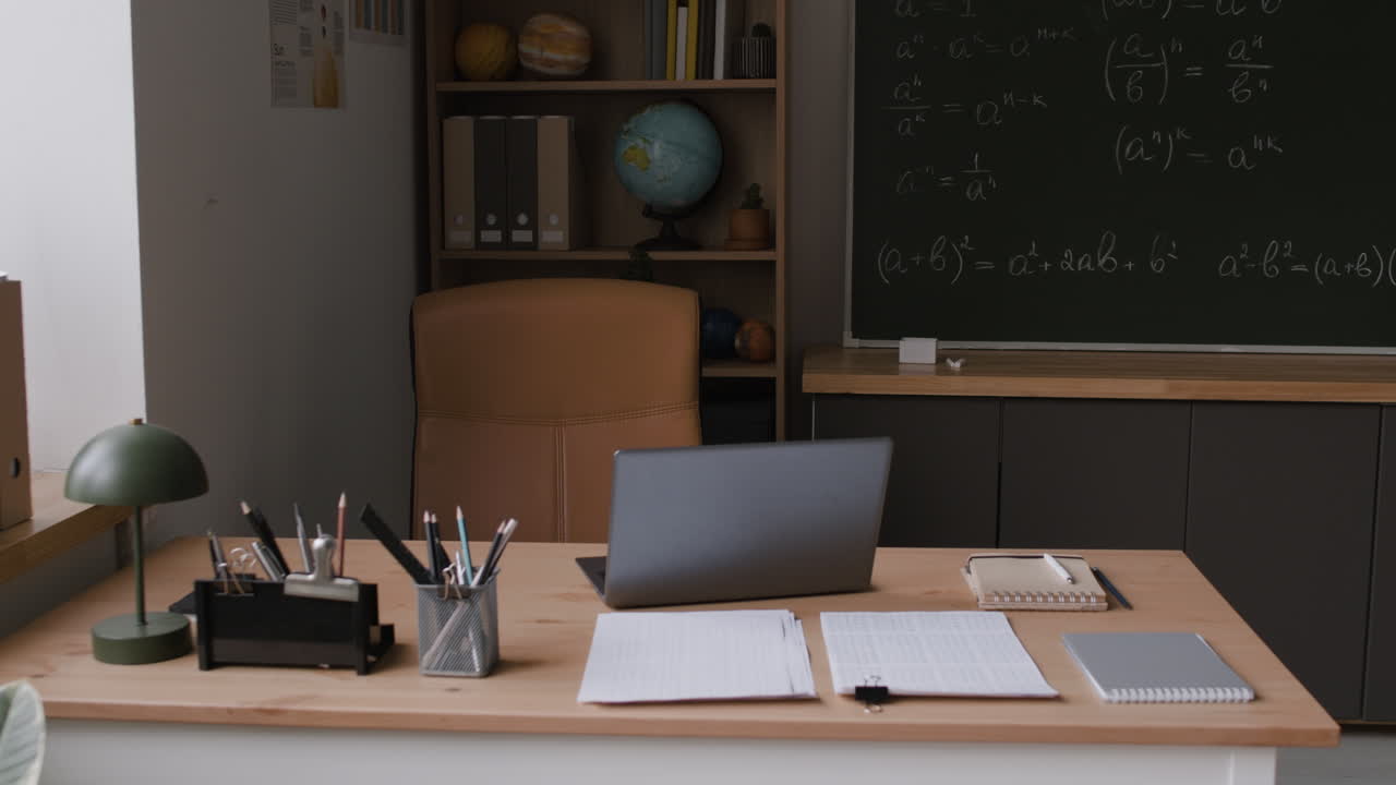 Classroom Study Space with Laptop and Math Equations on Chalkboard