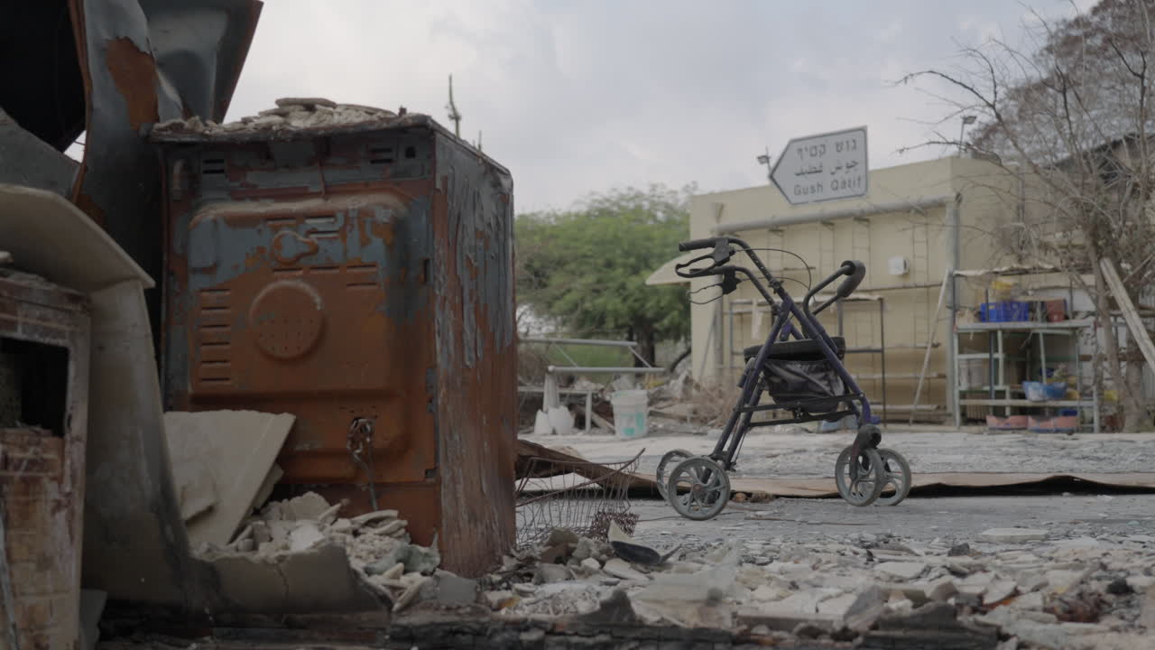 Completely Destroyed home in Kibbutz Nir Oz after Hamas attack, Walkers For Seniors, Gush Katif sign