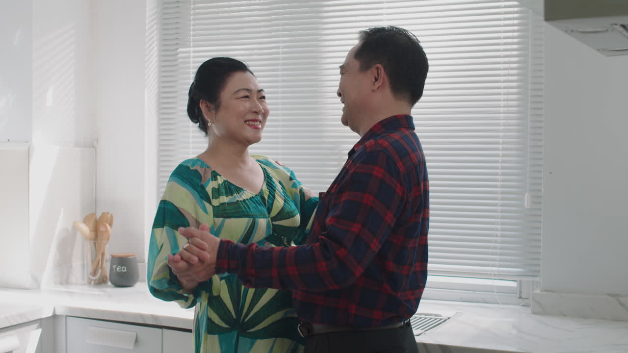 Asian Spouses Talking while Enjoying Romantic Dance