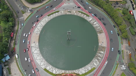 Traffic-Circles-Bundaran-HI-Roundabout-In-Central-Jakarta-Near-Grand-Indonesia-Drone-Pull-Back