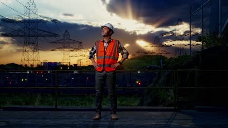 engineer at power plant at sunset