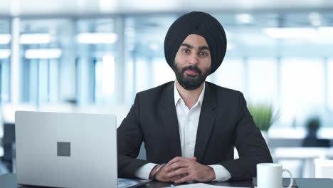 happy sikh indian businessman smiling to the camera