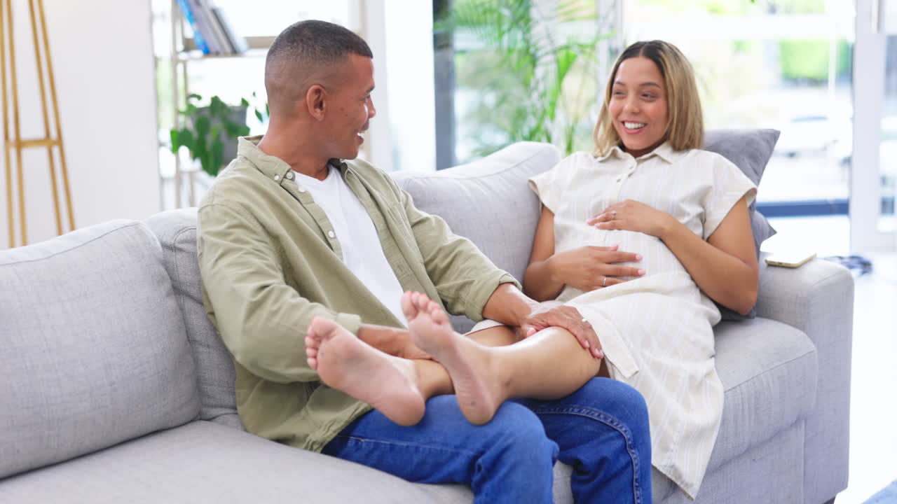 Happy, foot massage and man with his pregnant wife