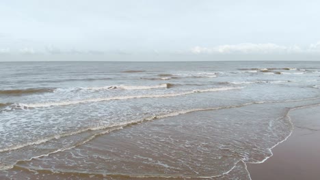 Foamy-Waves-Rolling-On-The-Shore-At-The-North-Sea-Beach-In-South-Holland,-Netherlands