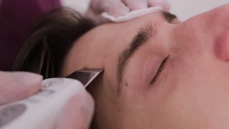 close-up of a person receiving a facial skincare treatment