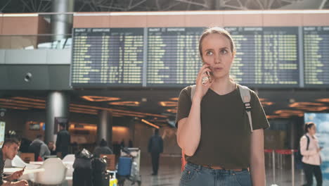 Woman-talking-on-the-phone-discussing-the-details-of-his-trip-and-booking-a-car-after-landing