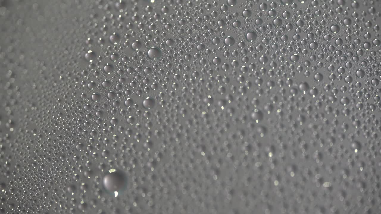 Water Droplets Forming on Glass from Steam