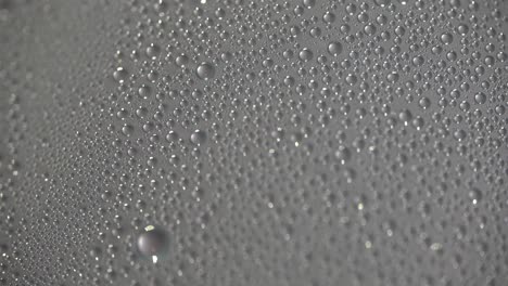 water droplets forming on glass from steam