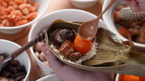Making zongzi food - preparing and wrapping Chinese rice dumpling.