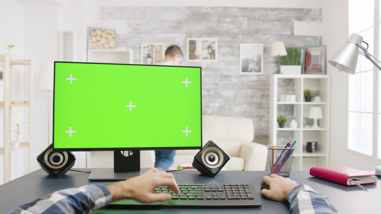 Home office workstation with green screen monitor