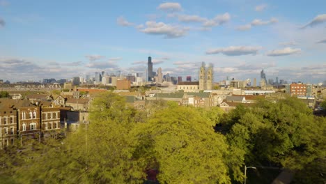 drone flying away from pilsen neighborhood on beautiful fall afternoon in chicago, illinois