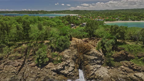 kudawella sri lanka aerial v4 natural phenomena of hummanaya blowhole with powerful sea water rushing through rocky cavern and water shoot up of the rock hole - shot with mavic 3 cine - april 2023