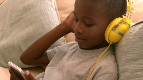 Little-boy-listening-to-music-on-the-couch