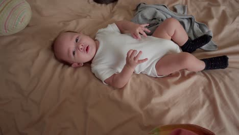 4-month-old-baby-moving-in-bed