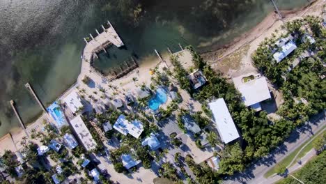 Aerial-birds-eye-footage-of-a-swimming-pool-a-resort-on-the-island-of-Islamorada,-Florida-Keys,-FL