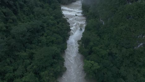 reveal shot of brown semuc champey waterfall at guatemala, aerial