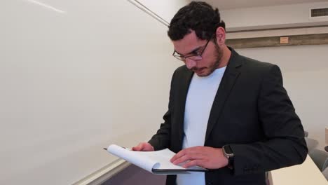 teacher using notes to write on the board