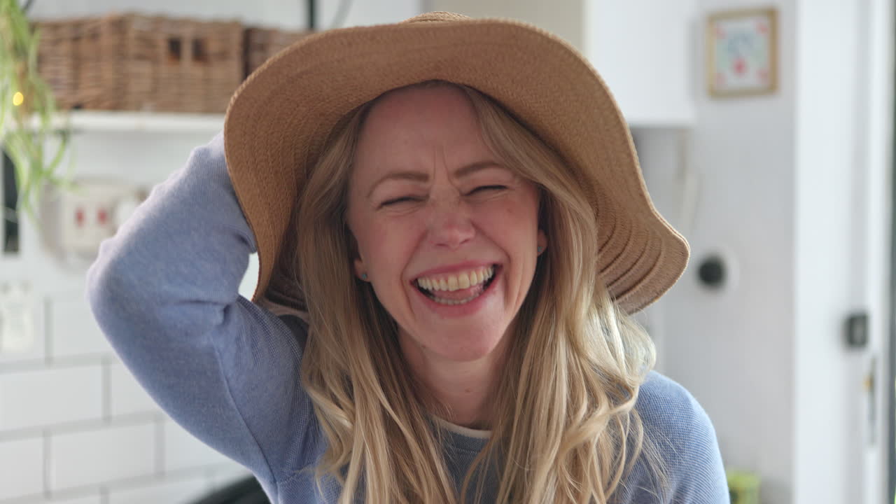 Woman laughing with hat on