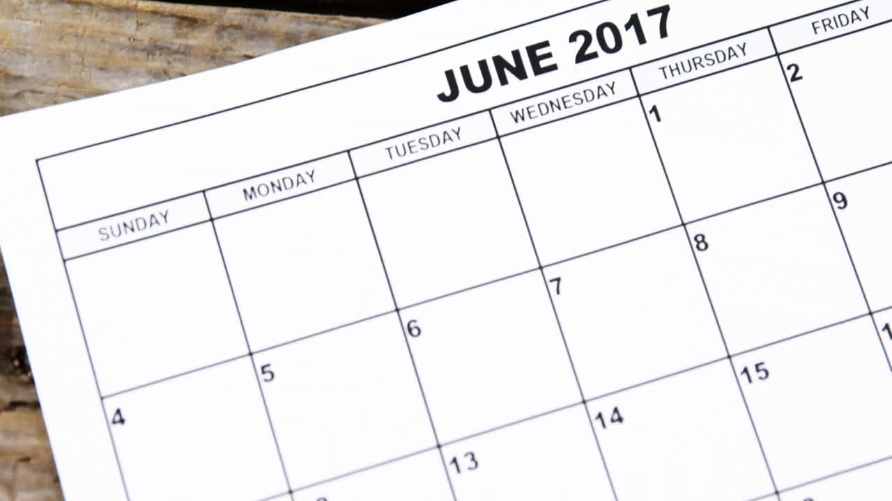 Fathers day marked with red heart in the calendar on wooden plank