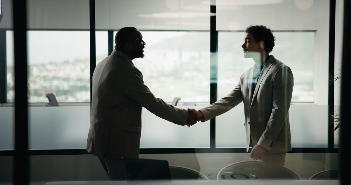 Two Businessmen Shaking Hands and Discussing in Modern Office